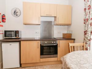 a kitchen with wooden cabinets and a stove top oven at Spire View in Pickering