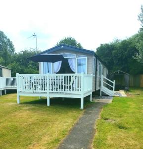 a house with a porch with an umbrella at Luxury Latest Model Holiday Home in Blackpool