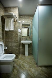a bathroom with a sink and a toilet and a shower at Kristal Inn Hotel in Baku