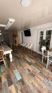 a room with a table and chairs and a tv at ART HOUSE 33 in Kutaisi