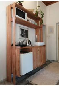 a small kitchen with a sink and a microwave at Flaneurstudio in Szentendre