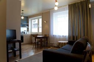 a living room with a couch and a table and a kitchen at Prenzel Apartments - City in Pärnu