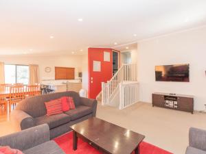 una sala de estar con un sofá y una mesa en Boronia 5 30 Nettin Circuit, en Jindabyne