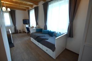 a bedroom with a bed with blue pillows at A tornácos panzió in Kéthely