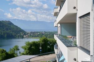 a balcony of a building with a view of a lake at Top 20 Alpe Maritima - Ferienapartment Alps & Lake in Annenheim