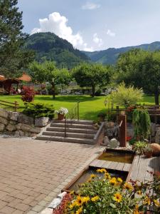 a garden with stairs and flowers in a park at Landhaus Rieser in Bad Hofgastein