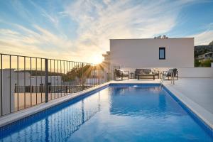 a swimming pool on the balcony of a house at Villa Maxima with heated pool - Makarska Veliko Brdo in Makarska
