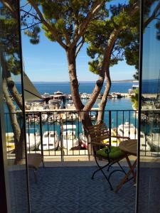 a balcony with a chair and a view of the water at Apartment Pupa in Brela