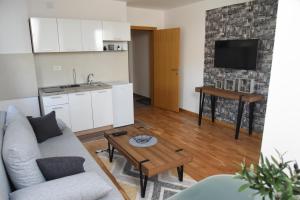 a living room with a couch and a table at Millenium apartment in Soko Banja