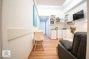 a living room with a couch and a table at Syntagma Square Athenian apartments in Athens