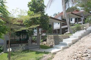 a house on a hill with stairs and trees at Sun Moon Star Resort Koh Phangan in Haad Yao