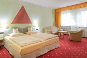 Posteľ alebo postele v izbe v ubytovaní Goldener Schwan Hotel Garni