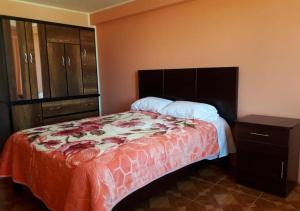 a bedroom with a large bed with a dresser and a bed sidx sidx sidx at La Azotea in Huancayo