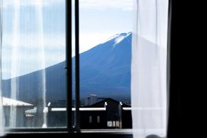 
a window with a view of a mountain at Fuji Guest House Ao in Fujikawaguchiko
