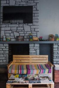 a bed in a living room with a stone fireplace at Madagascar Underground in Antananarivo