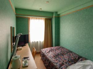 Tempat tidur dalam kamar di Yuzawa Royal hotel