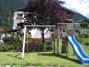 a playground with a blue slide in a yard at Haus Ausserbach in Gaschurn