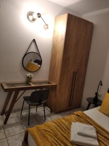 a bedroom with a desk and a mirror and a bed at Studios Anais - Thasos in Limenas