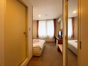 Postel nebo postele na pokoji v ubytování Hotel Ginsui