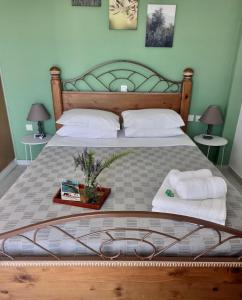A bed or beds in a room at Anastasios Olive Garden Apartments
