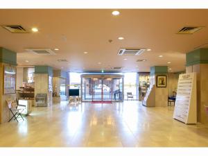 a large lobby with a hallway with tables and chairs at Yuzawa Royal hotel in Yuzawa