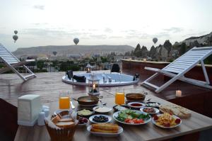 a table topped with plates of food and drinks at Hostel Terra Vista in Goreme