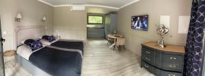 a bedroom with a bed and a table in it at Le chêne in Saint-Sébastien-sur-Loire