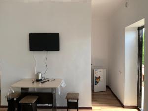 a room with a table and a television on a wall at Delfin Murok in Bosteri +20 photos