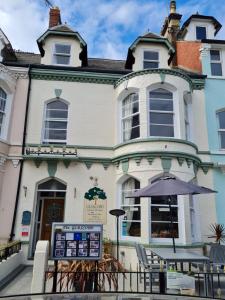 a building with an umbrella in front of it at Glascoed Guest House in Llandudno