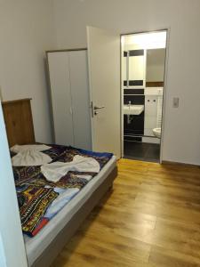 a bedroom with a bed and a bathroom with a mirror at Hotel hostel Zafir in Berlin