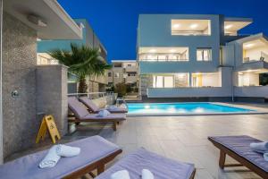 a villa with a swimming pool and a house at Apartments & Rooms Danivan Pool Villas in Novalja