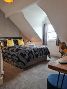 a bedroom with a bed in a attic at Glascoed Guest House in Llandudno