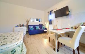 a living room with a table and a blue couch at Apartment Nena in Krk