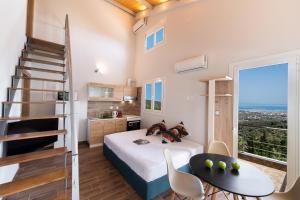 a bedroom with a bed and a staircase and a table at Vista Del Diamante Apartments in Apolpaina