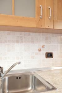 a kitchen with a sink and a counter top at Appartamenti Lea Pontiglia in Livigno