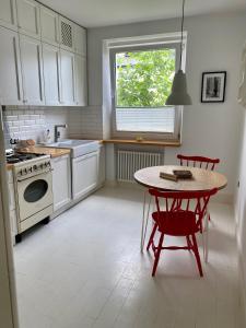 a kitchen with a table and a stove and a window at Chic Apartment in vibrant area - National Stadium - Saska Kępa in Warsaw