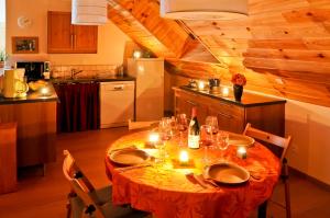 a kitchen with a table with candles on it at La cabane du bonheur, un gite écologique in Cornillon-en-Trièves