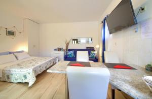 a bedroom with a bed and a table and chairs at Apartment Nena in Krk