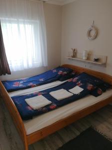 a bedroom with a bed with towels on it at Aleksandros in Mezőkövesd