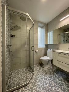 a bathroom with a shower and a toilet and a sink at Niidupuu Apartment in Kuressaare +17 photos