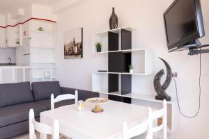 a living room with a white table and a couch at Apartamentos Miramar Playa in Raxó