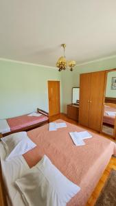 a bedroom with two beds and a mirror at Apartments Crljen in Brodarica