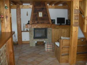 a living room with a fireplace in a cabin at Chalet L' Irrawaddy in Megève