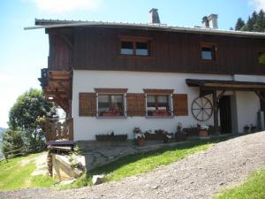 a house on a hill with flowers in front of it at Chalet L' Irrawaddy in Megève
