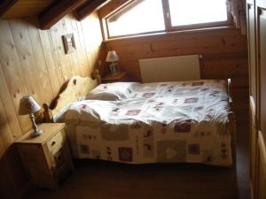 a bedroom with a bed in a room with a window at Chalet L' Irrawaddy in Megève