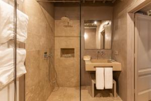 a bathroom with a shower and a sink at Drogheria e Locanda Franci in Montalcino