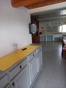 a kitchen with a counter with a yellow counter top at Letizia in Donnalucata
