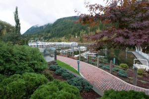 a garden in a marina with mountains in the background at Super 8 by Wyndham Sicamous in Sicamous