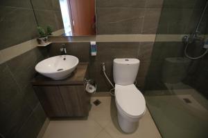 a bathroom with a white toilet and a sink at Ara Garden Inn, Accommodation, Yoga studio & Spa in Ruteng +9 photos