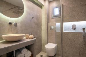 a bathroom with a sink and a toilet and a shower at Ammos Kalamitsi in Kalamitsi